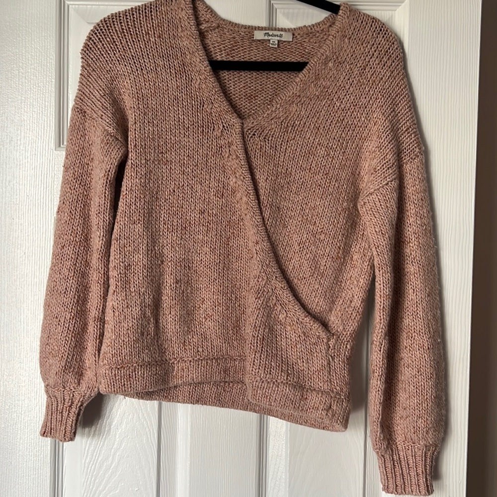 Pink sweater with brown/orange details in yarn